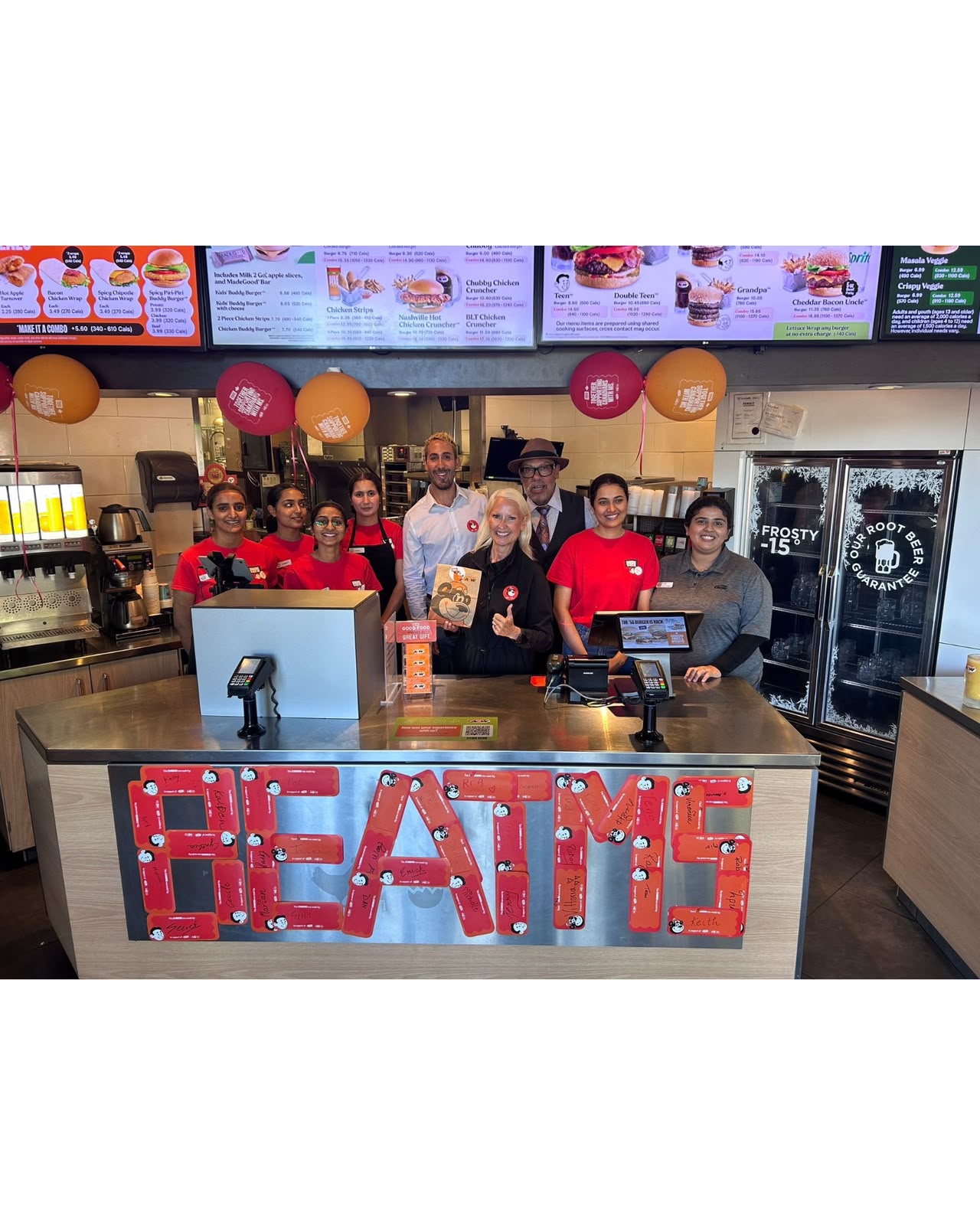 A&W Como Lake team behind the counter with a Beat MS display